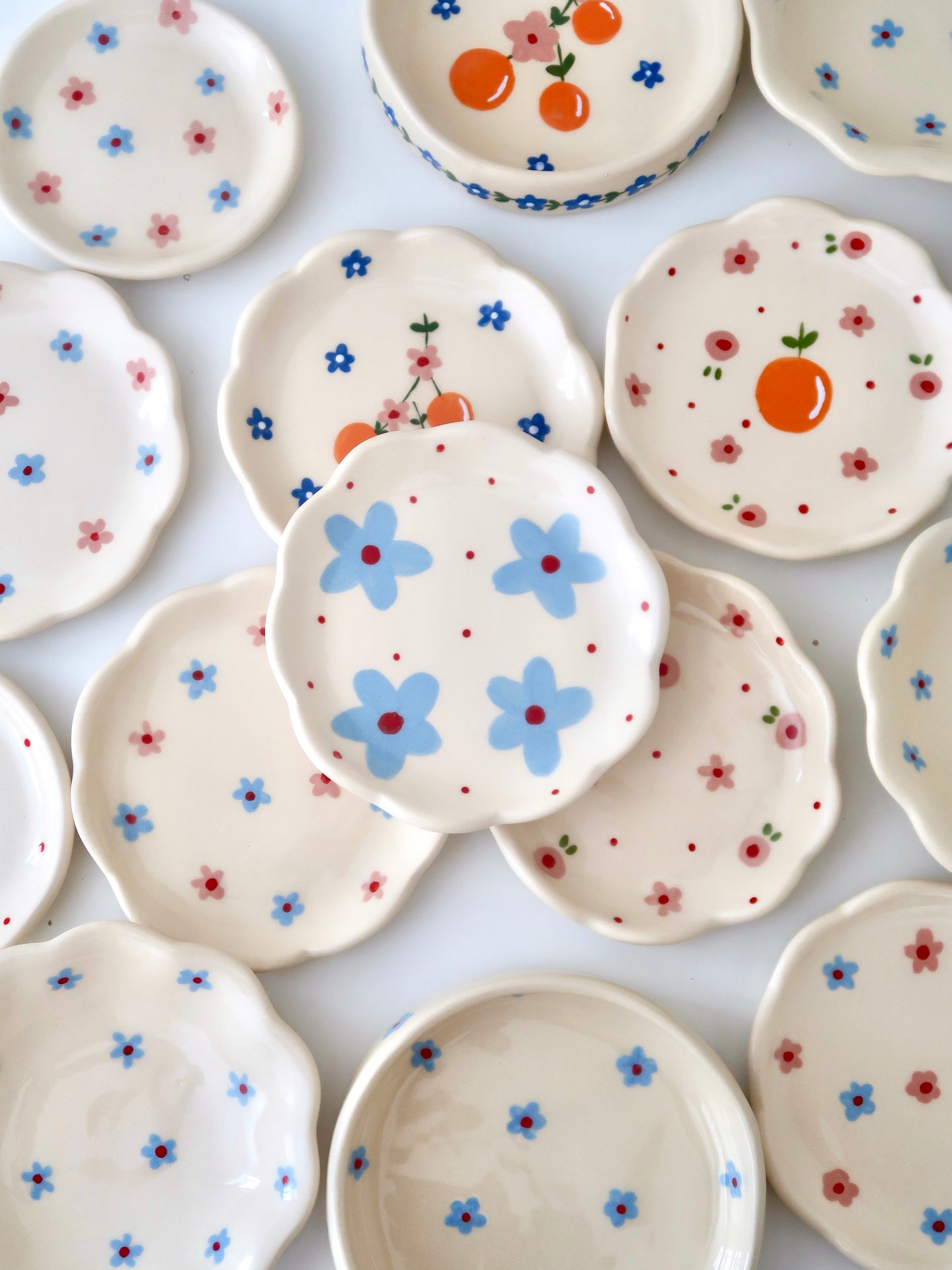 Scalloped ring dish with blue flowers and red dots