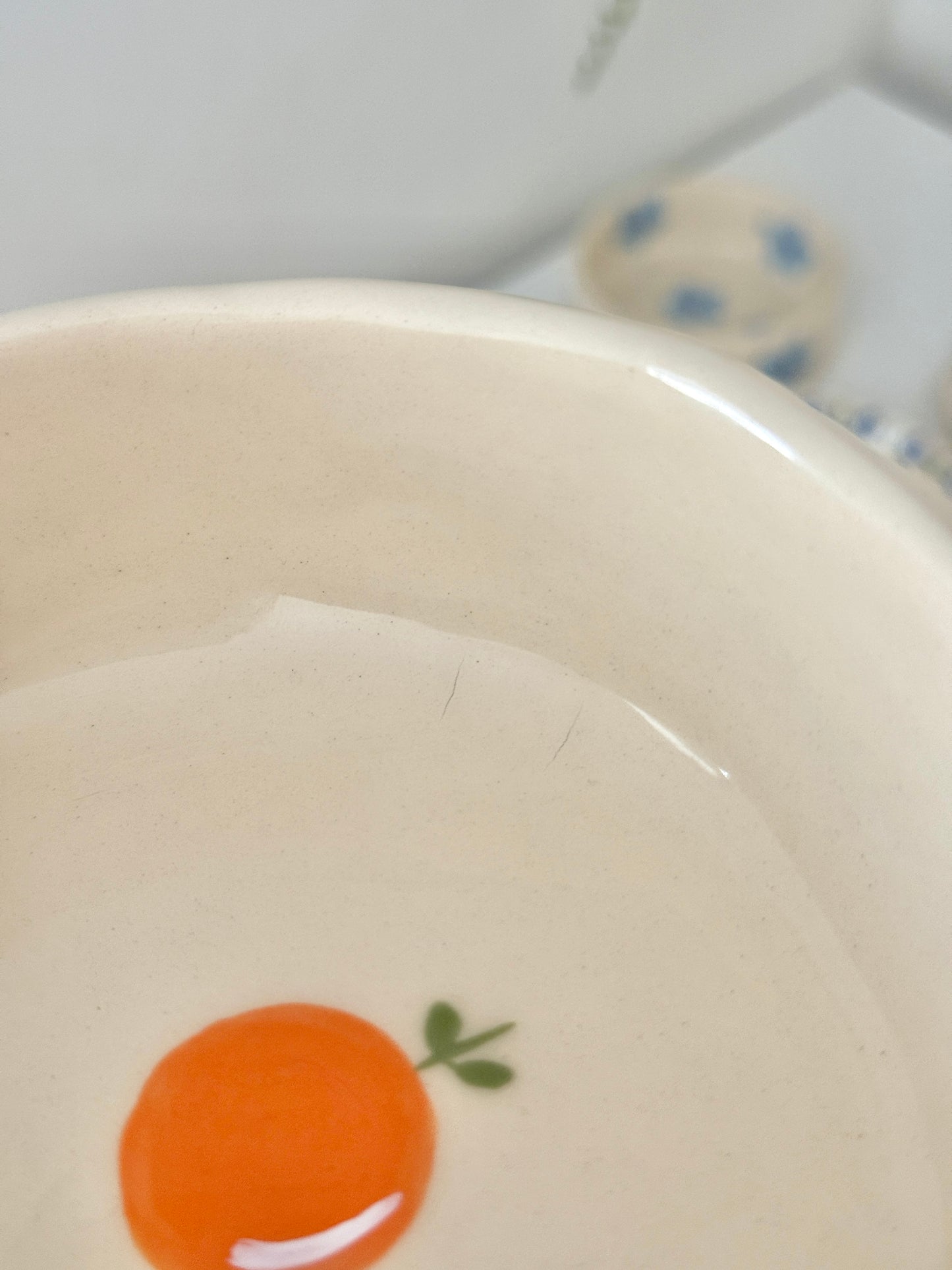 Bowl with oranges and blue flowers