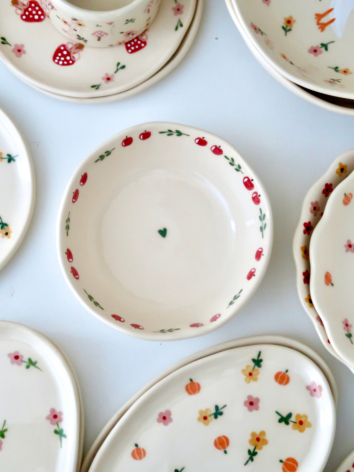 Bowl with an apple and green flowers