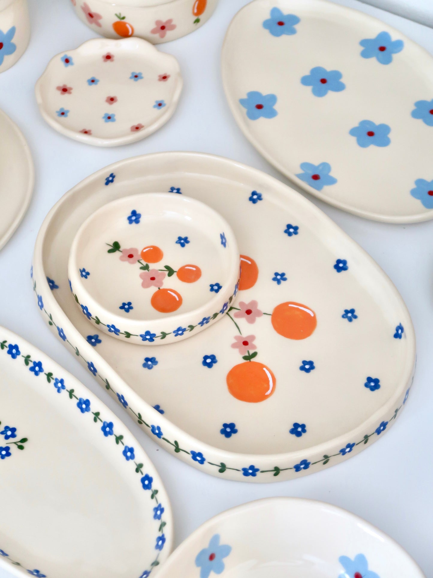 Ring dish with oranges and pink flowers