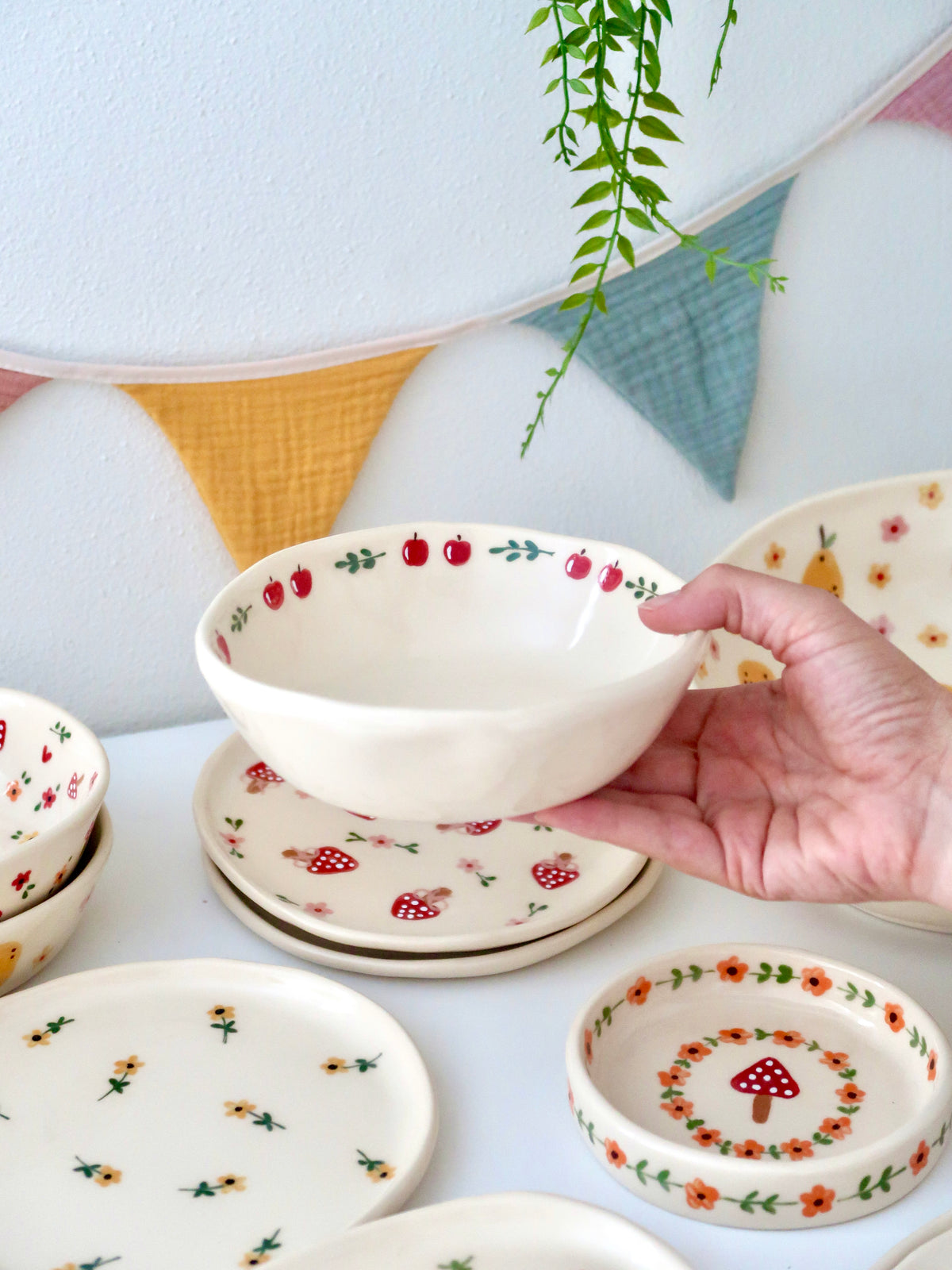 Bowl with an apple and green flowers