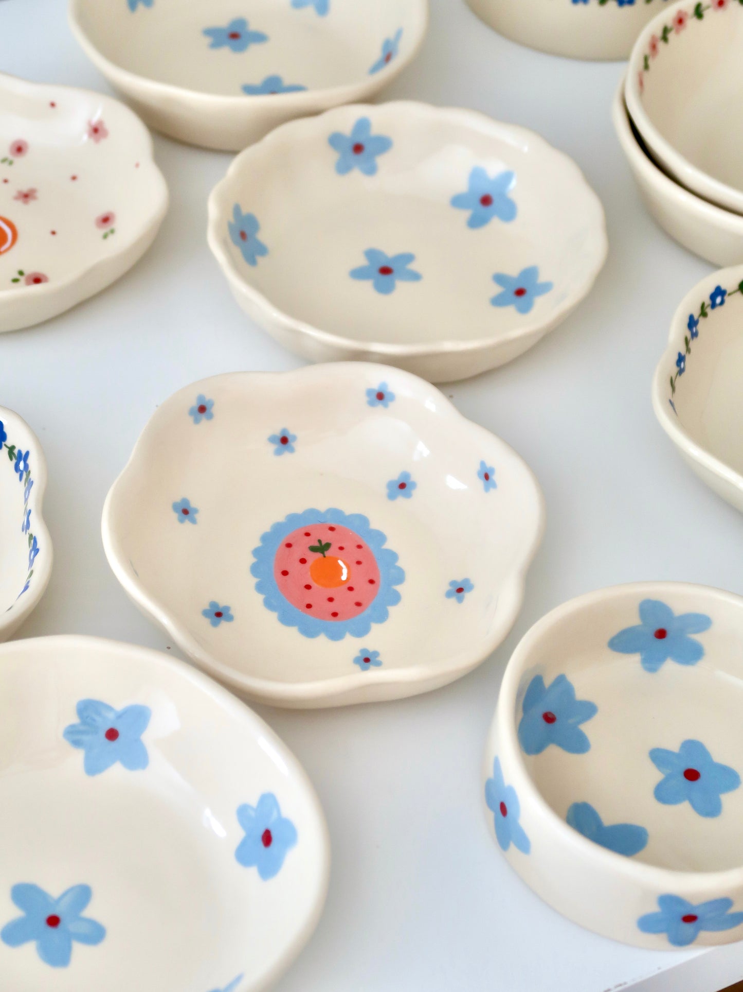 Scalloped bowl with orange and blue flowers