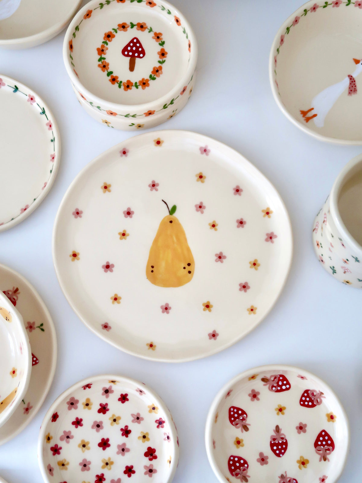 Plate with a pear, yellow and pink flowers