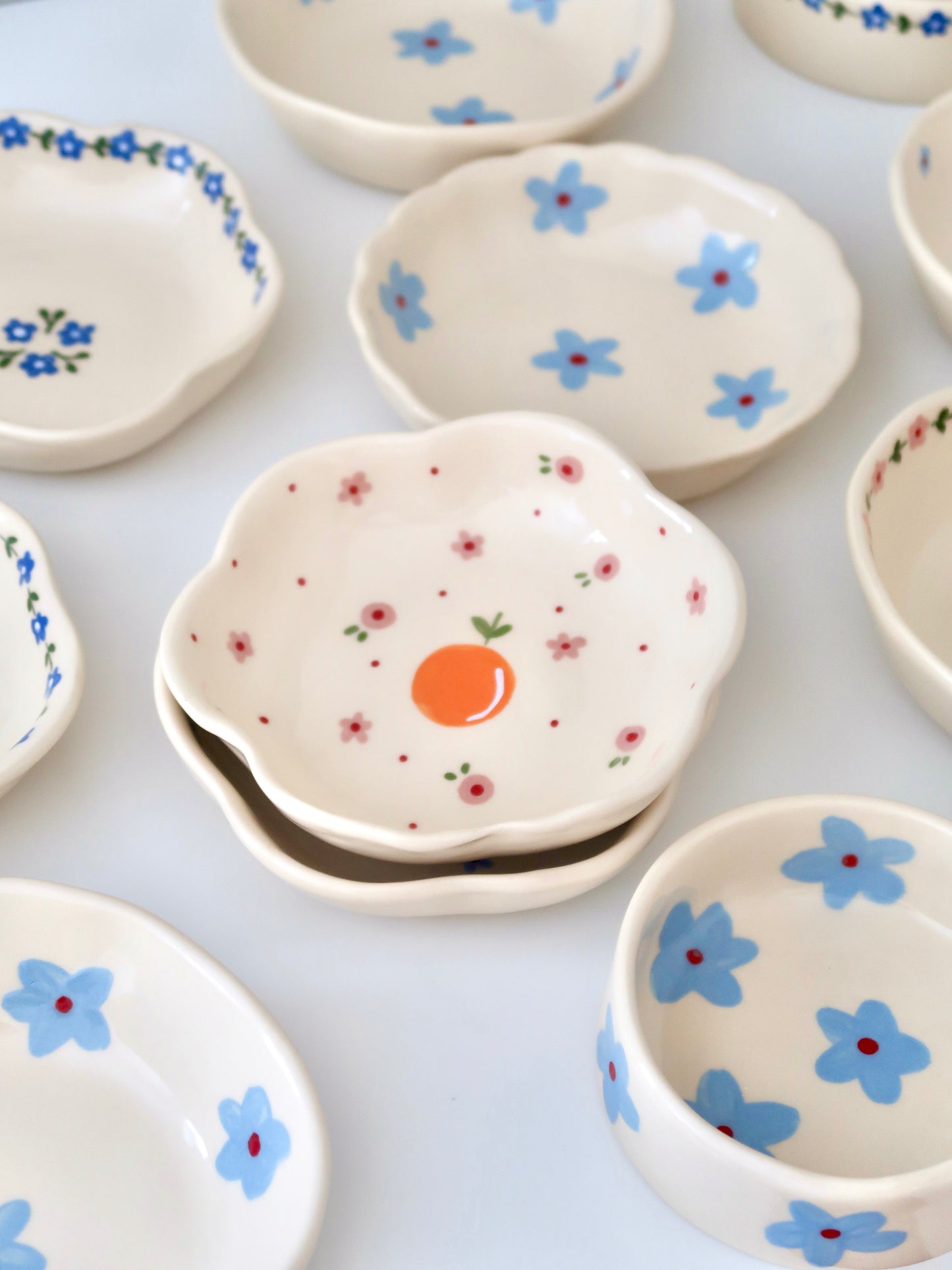 Scalloped bowl with orange and pink flowers