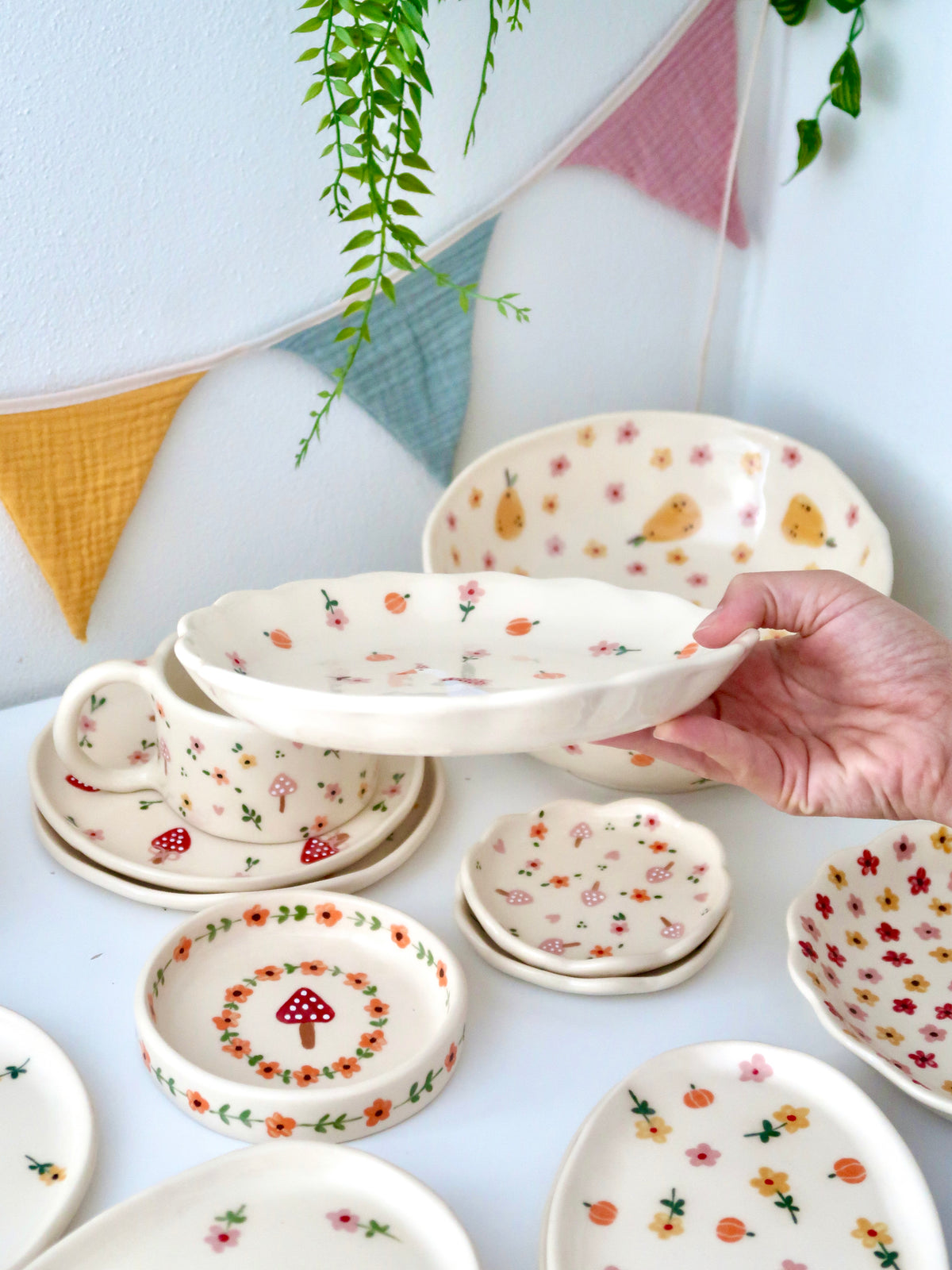 Scalloped plate with a duck, pumpkins, and pink flowers