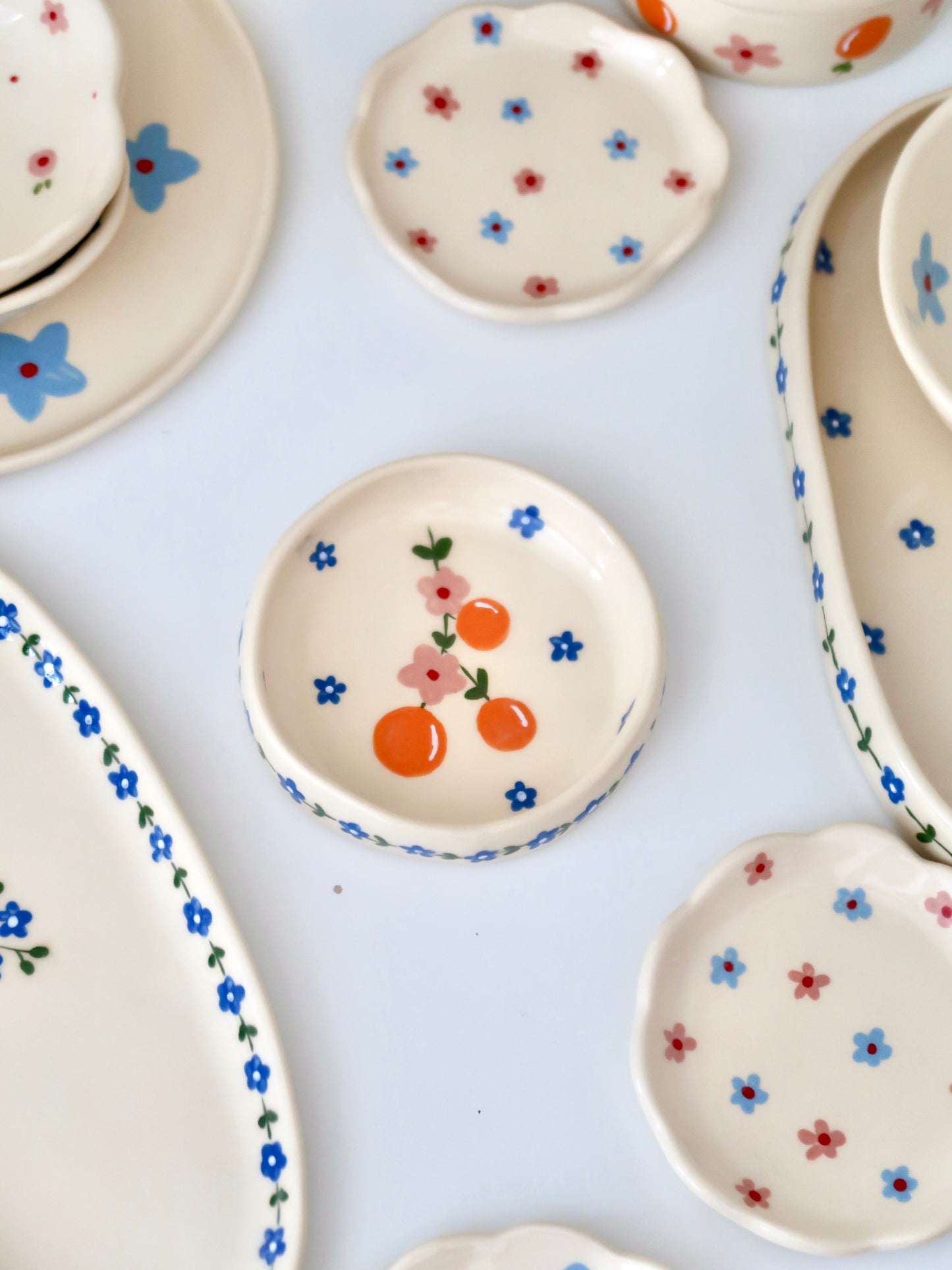 Ring dish with oranges and pink flowers