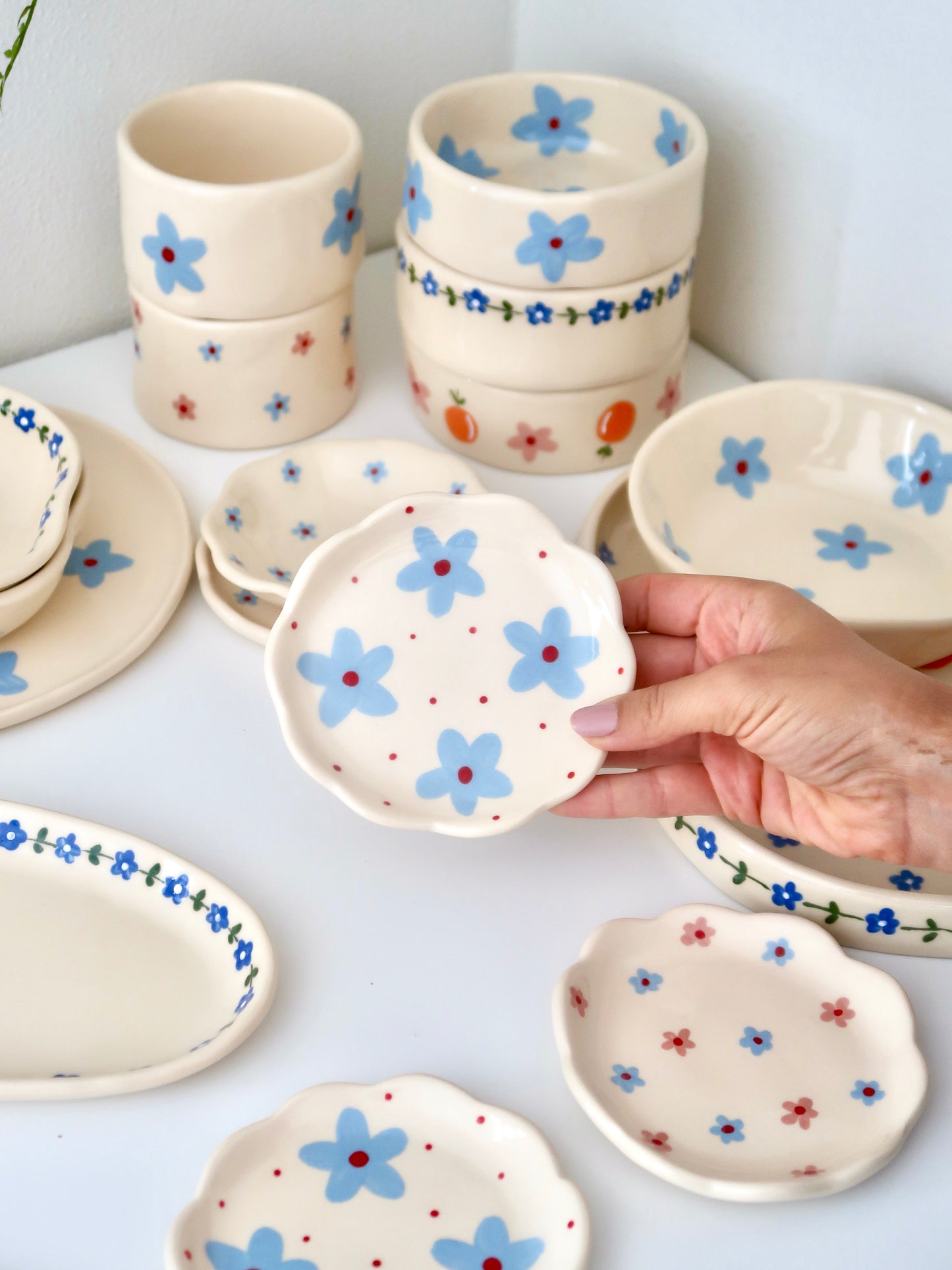 Scalloped ring dish with blue flowers and red dots