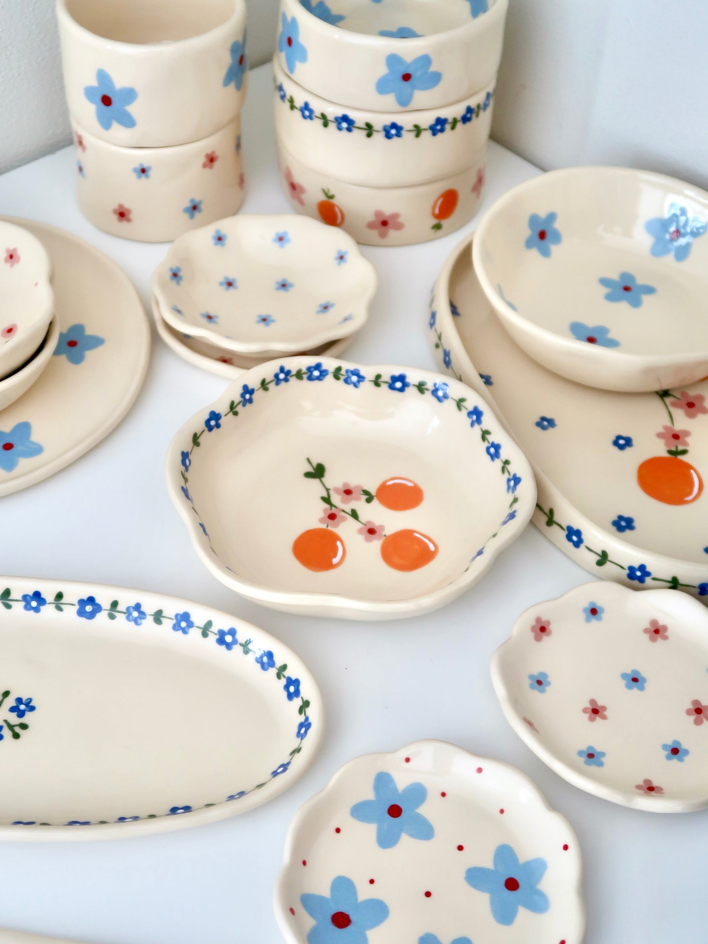 Scalloped bowl with oranges and blue flowers