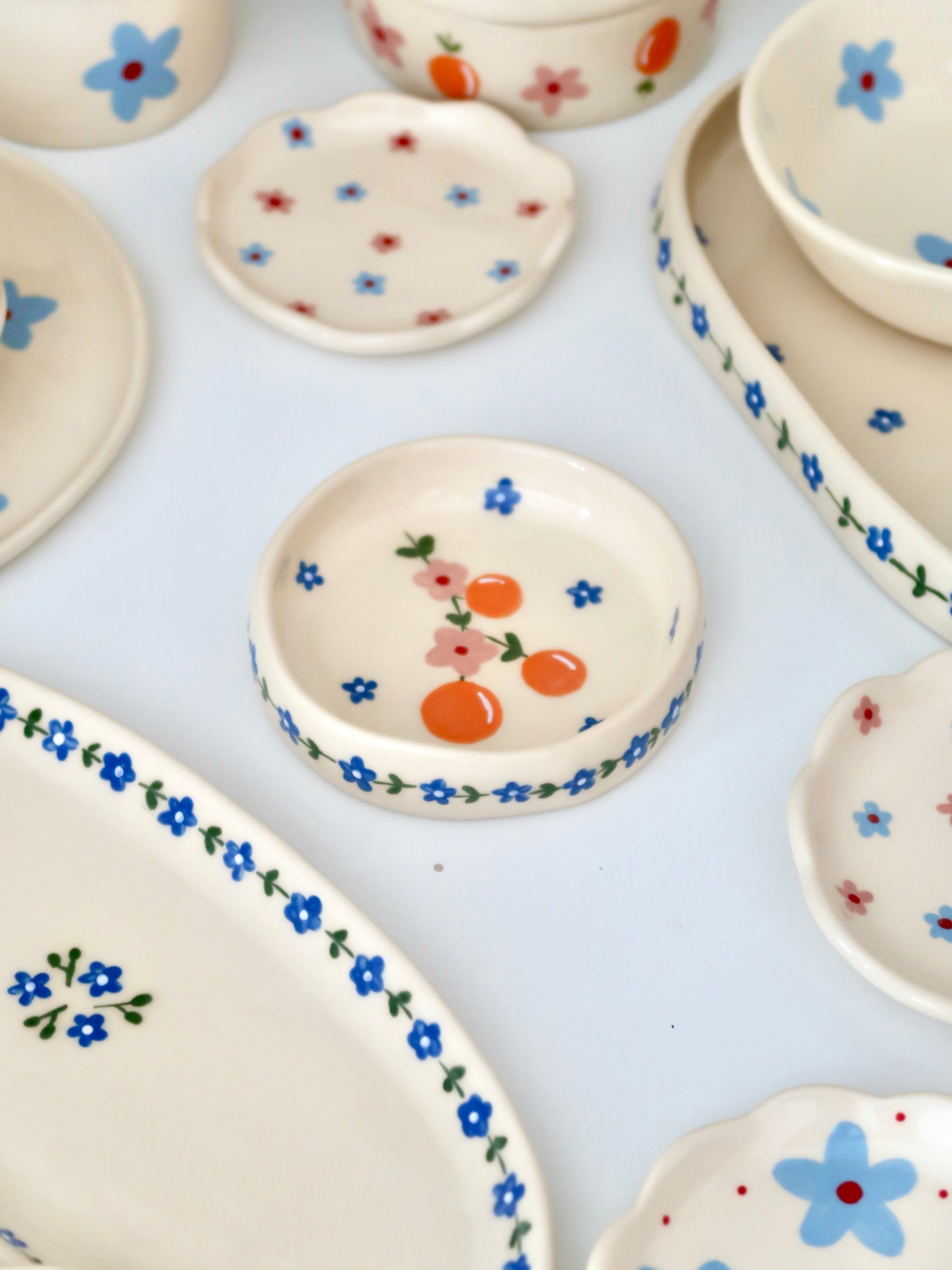 Ring dish with oranges and pink flowers