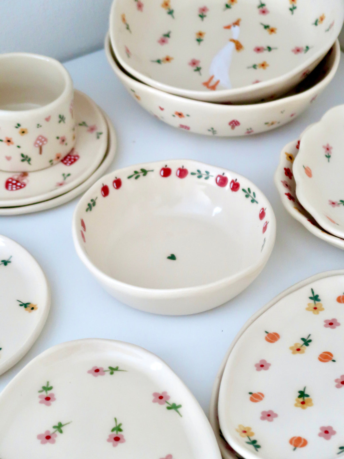 Bowl with an apple and green flowers