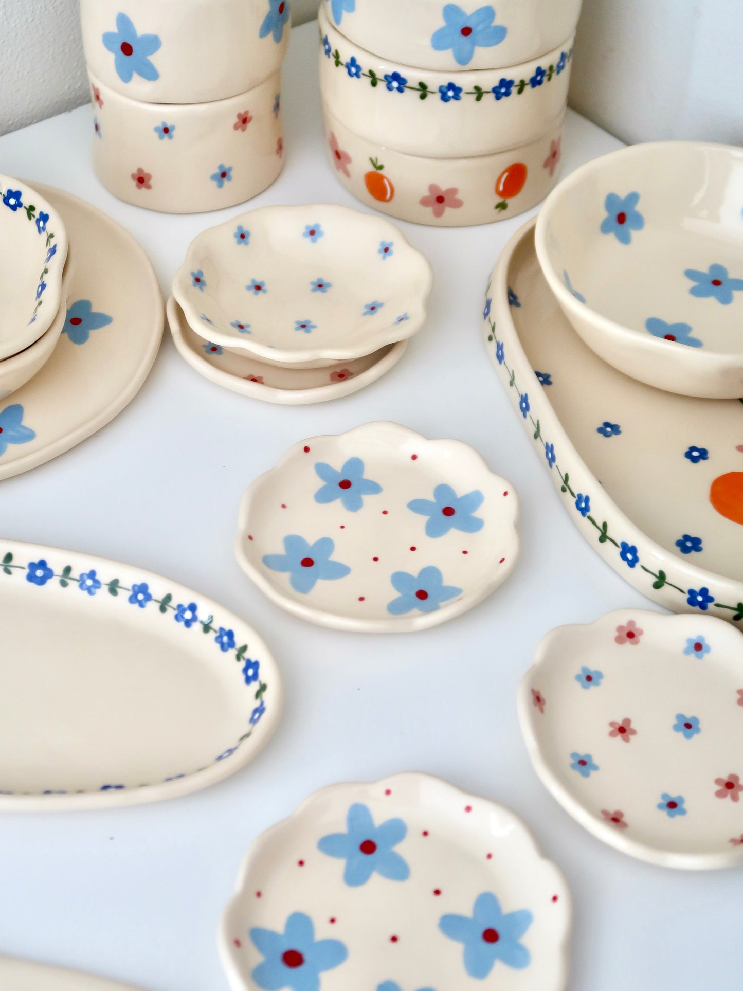 Scalloped ring dish with blue flowers and red dots