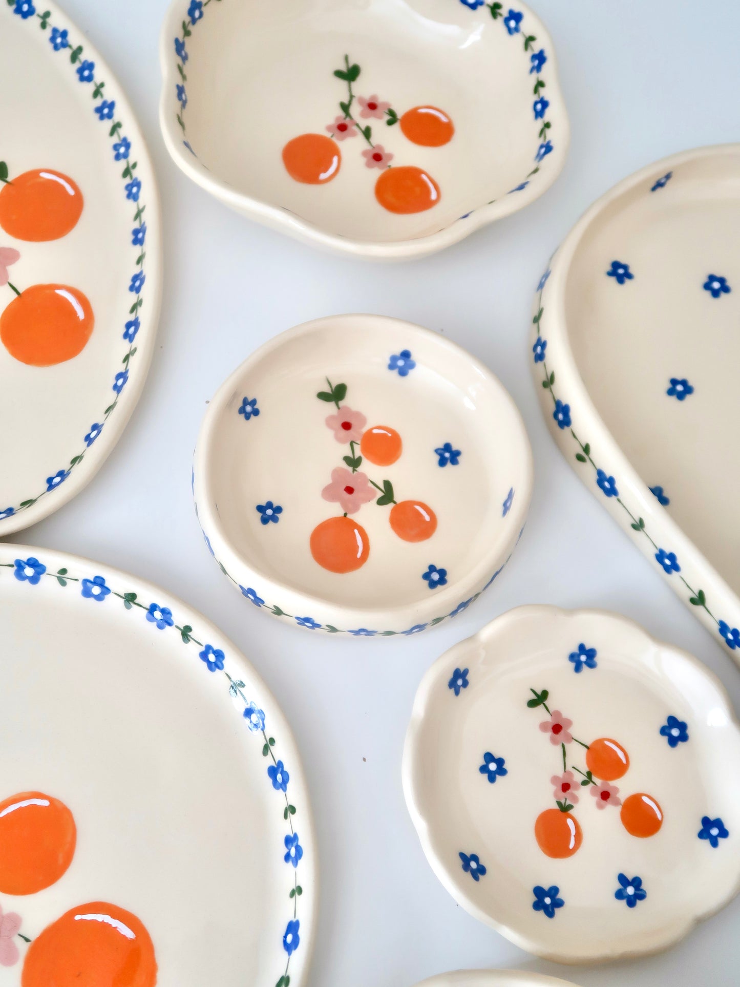 Ring dish with oranges and pink flowers
