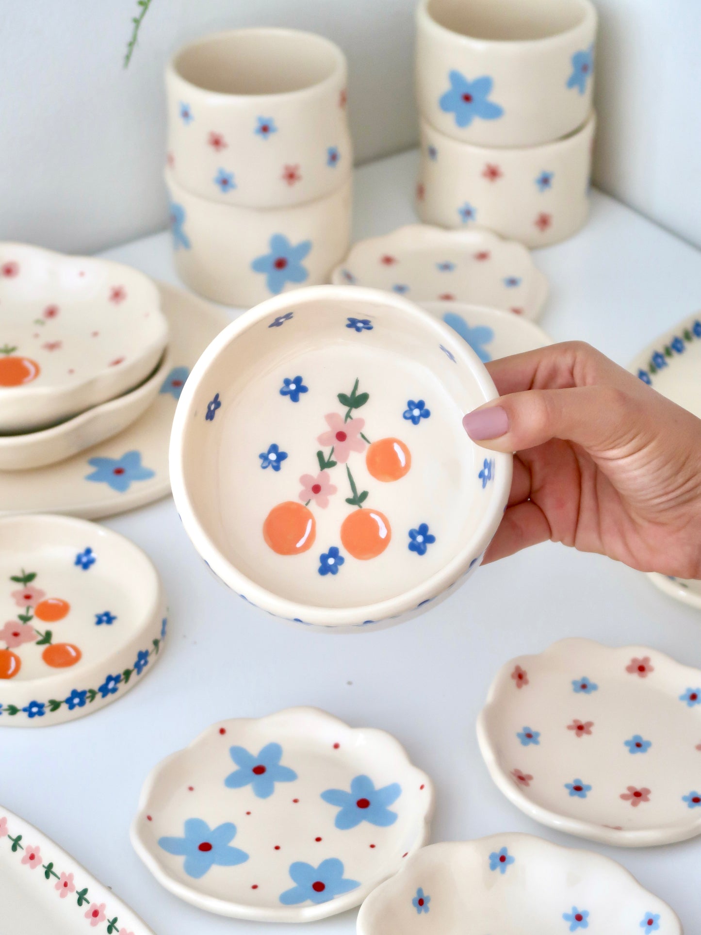 Bowl with oranges and pink flowers