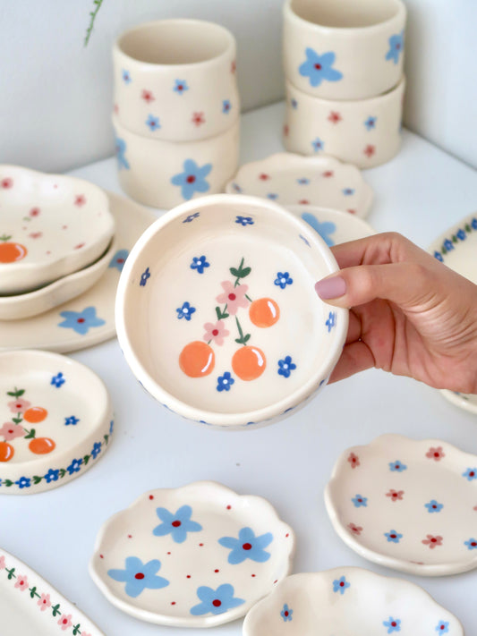 Bowl with oranges and pink flowers