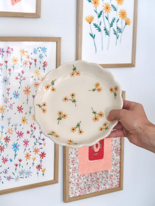Scalloped plate with yellow flowers