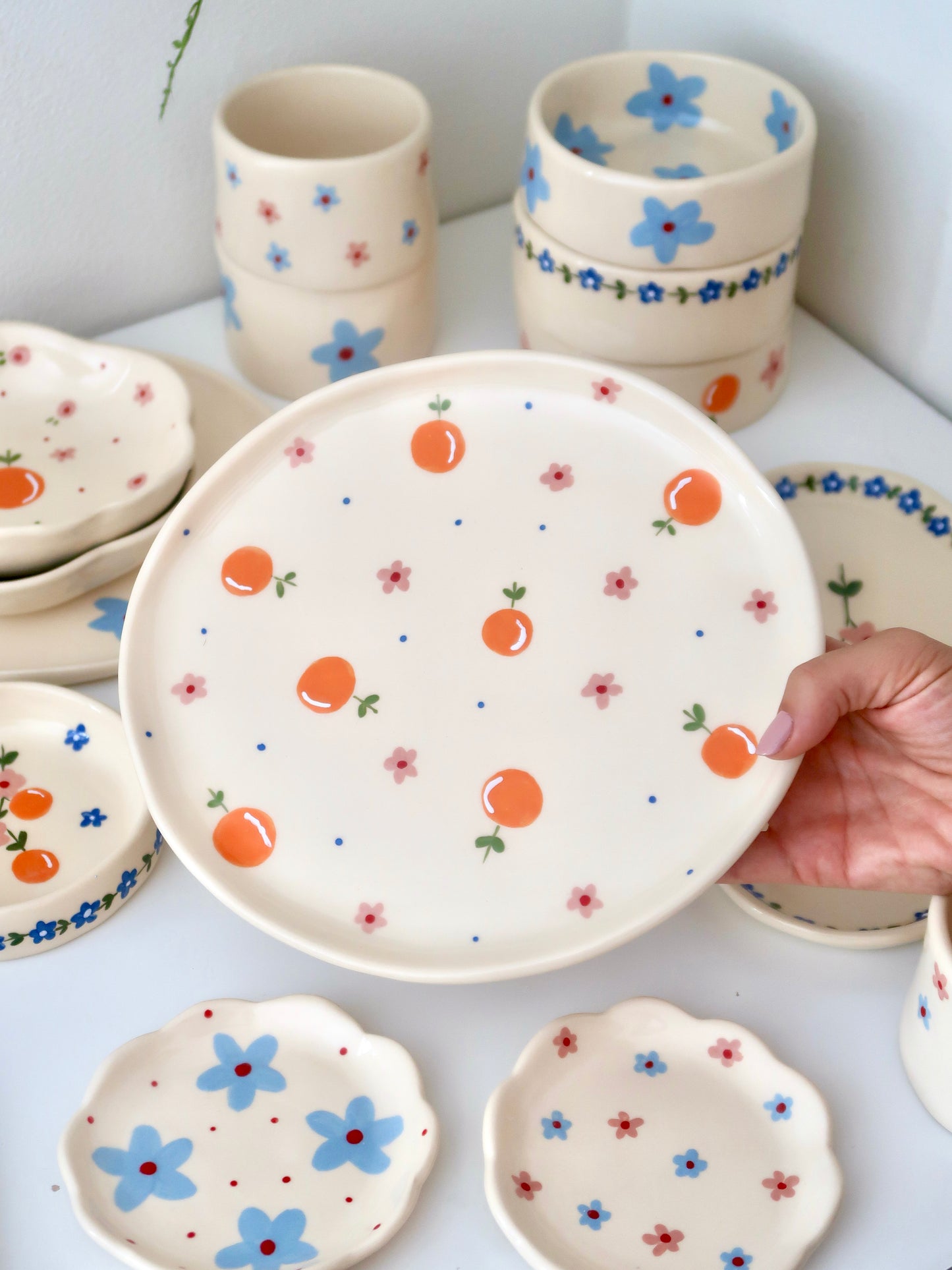 Plate with oranges, pink flowers and blue dots