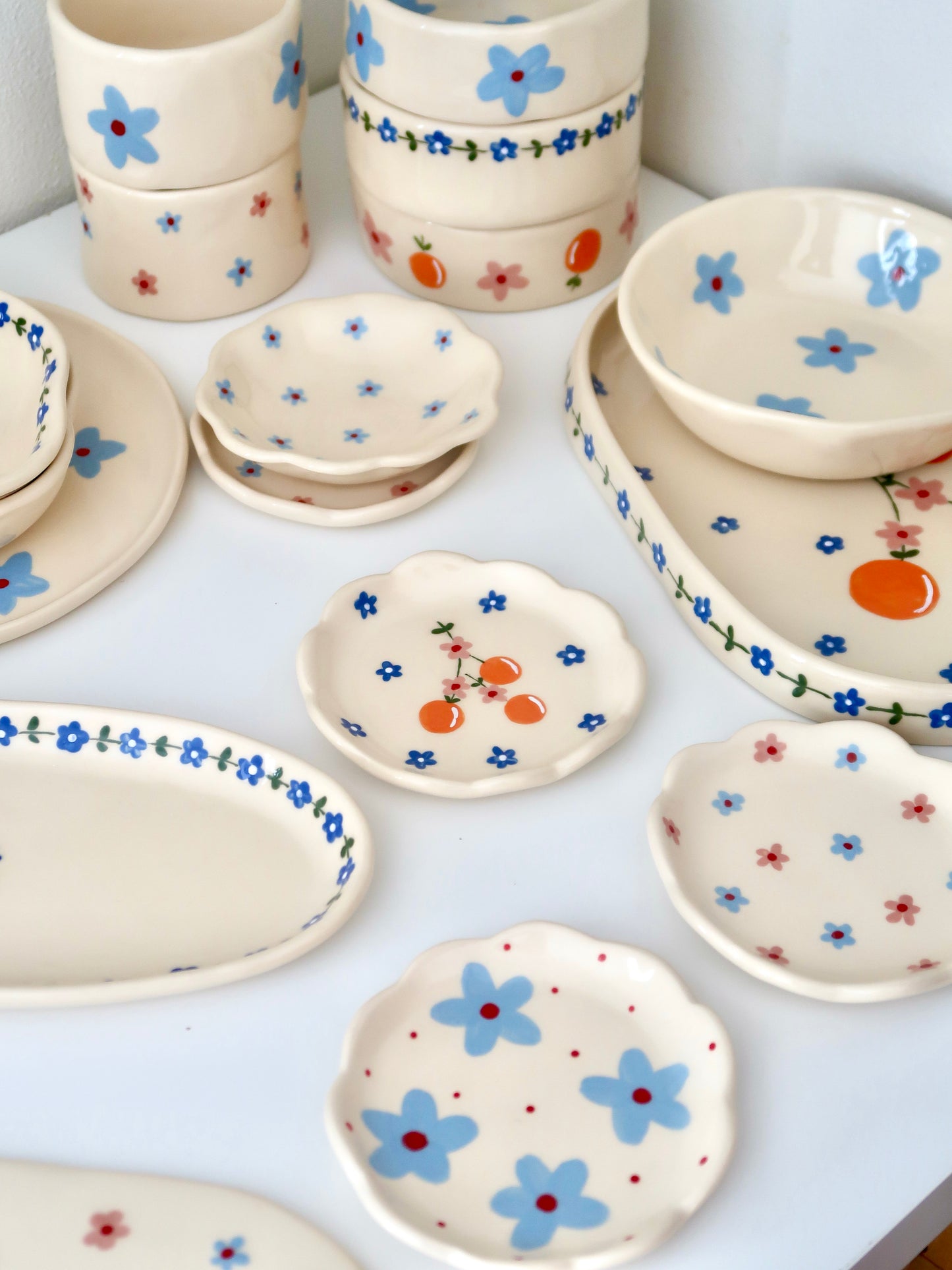 Scalloped ring dish with oranges and blue flowers