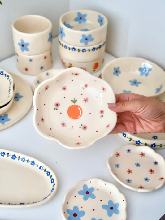 Scalloped bowl with orange and pink flowers