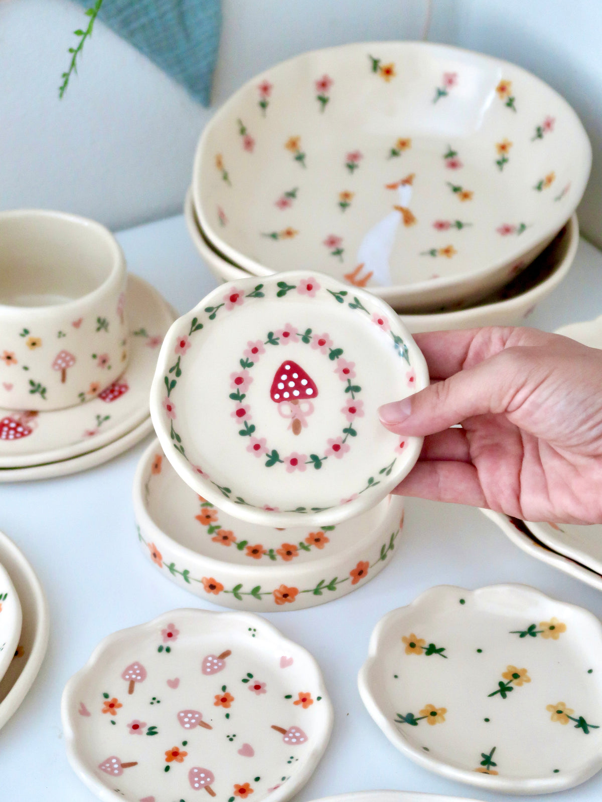 Scalloped ring dish with a mushroom and pink flowers