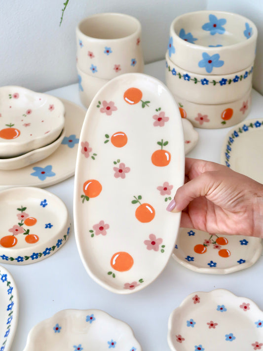 Platter with oranges and pink flowers