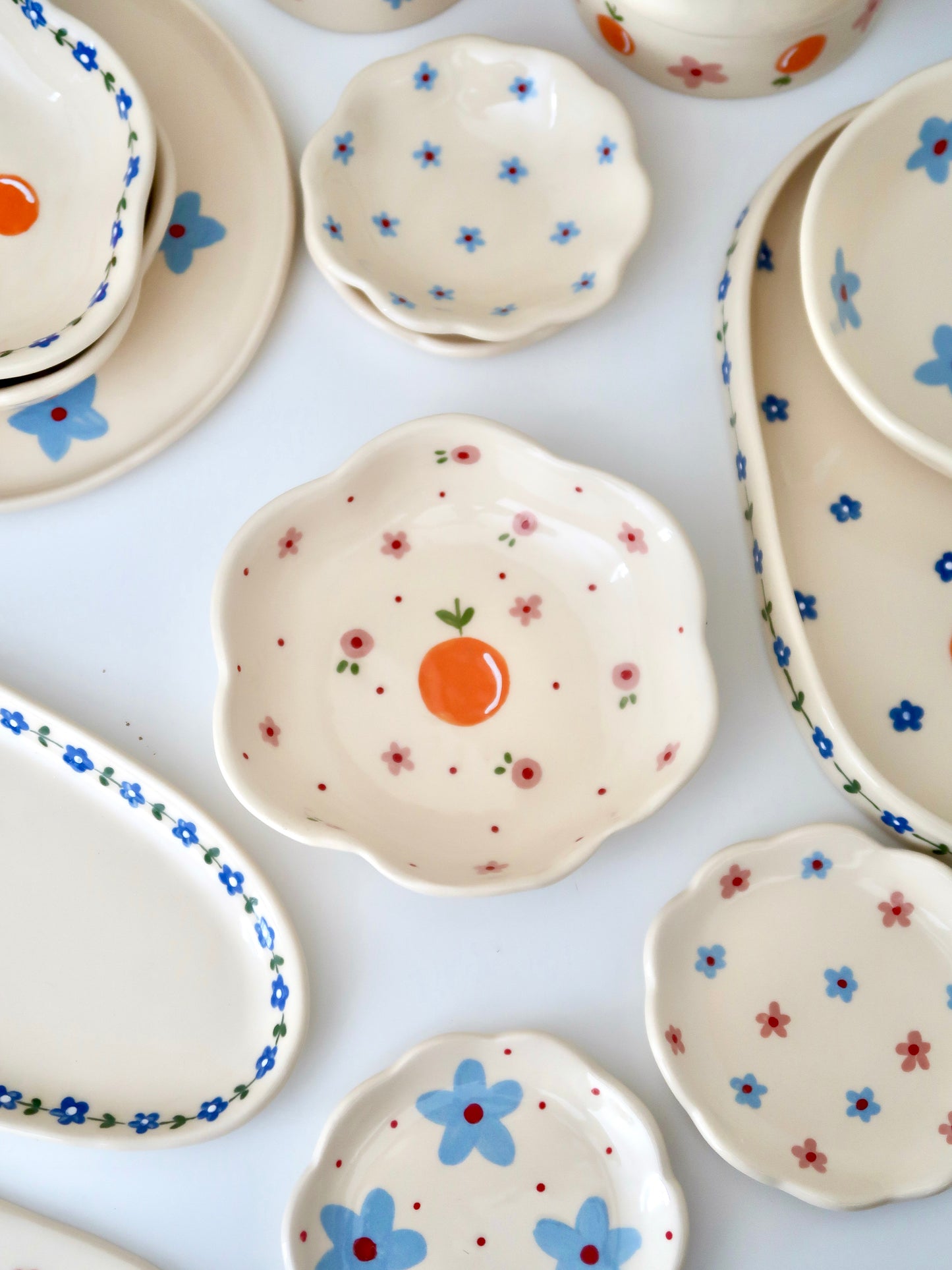 Scalloped bowl with orange and pink flowers