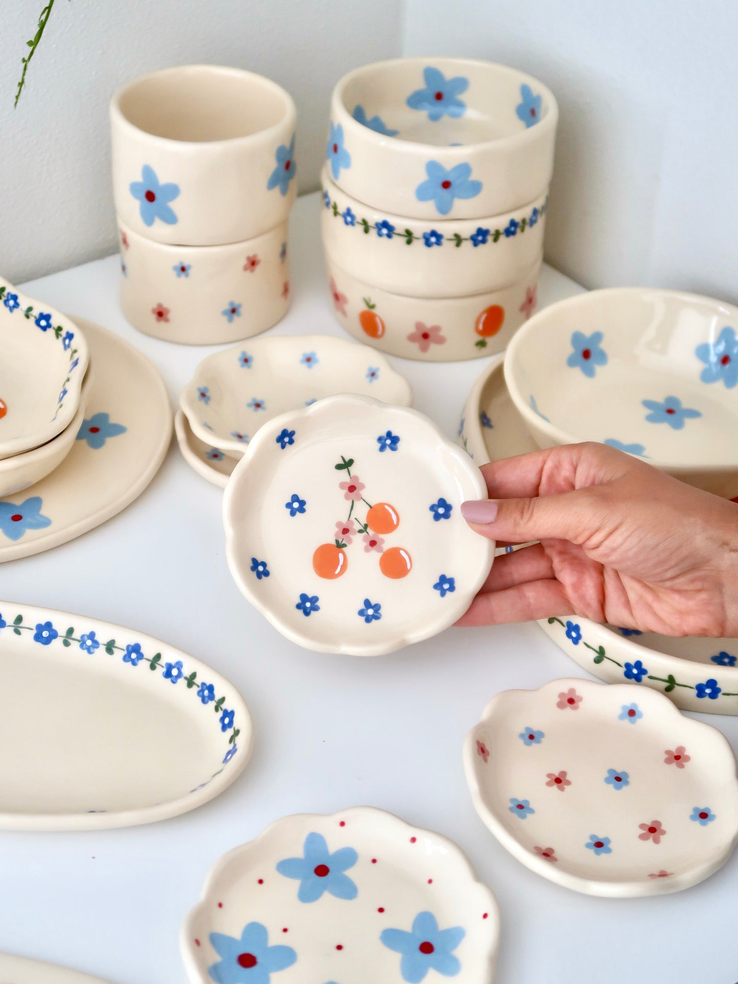 Scalloped ring dish with oranges and blue flowers