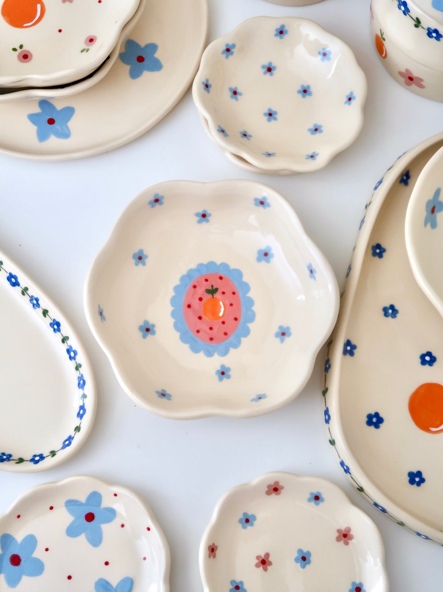 Scalloped bowl with orange and blue flowers