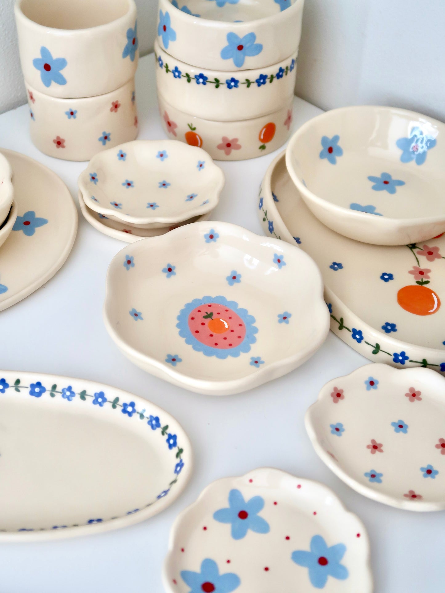 Scalloped bowl with orange and blue flowers