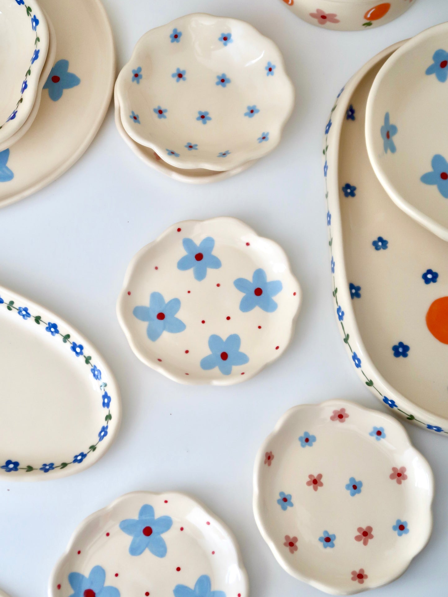 Scalloped ring dish with blue flowers and red dots