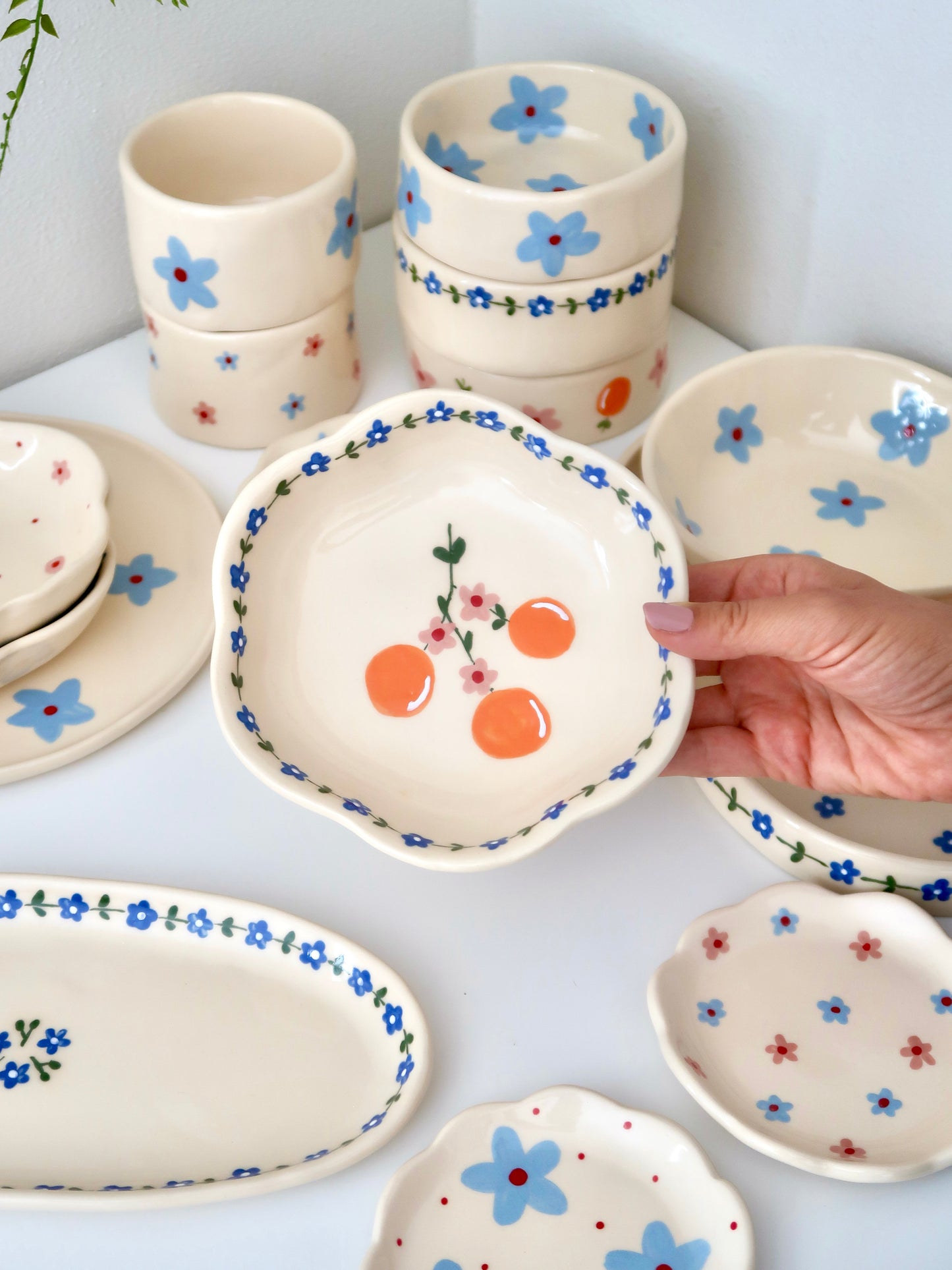 Scalloped bowl with oranges and blue flowers